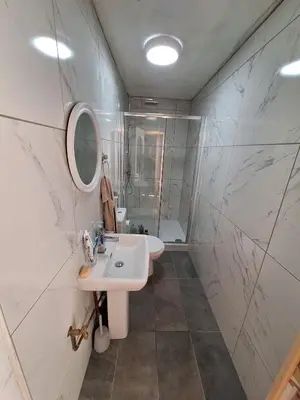 a white bathroom with a sink and a mirror at Liverpool Rooms Near City & Stadiums in Liverpool