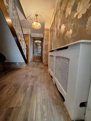 a hallway with a television and a staircase in a house at Liverpool Rooms Near City & Stadiums in Liverpool