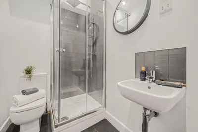 a bathroom with a toilet and a sink and a shower at Aurum House Luxury Apartments in Blackpool