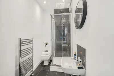 a bathroom with a toilet and a sink and a mirror at Aurum House Luxury Apartments in Blackpool