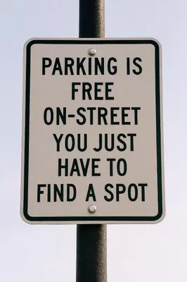 a sign on a pole that reads parking is free on street you just have to at Aurum House Luxury Apartments in Blackpool