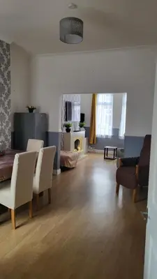 a living room with a couch and chairs and a fireplace at House4 holiday in Liverpool