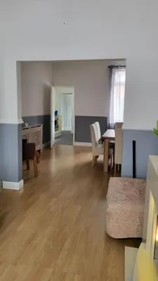 a living room with a table and a dining room at House4 holiday in Liverpool