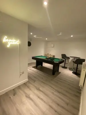 a room with a ping pong table and two chairs at Wadham Suites in Liverpool