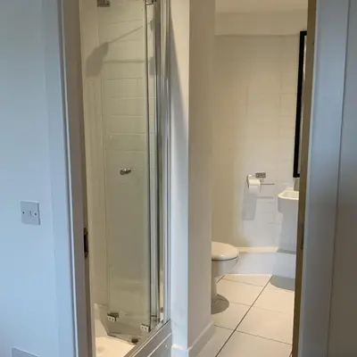 a bathroom with a glass shower and a toilet at Spacious City Centre 2 Bedroom Apartment in Liverpool