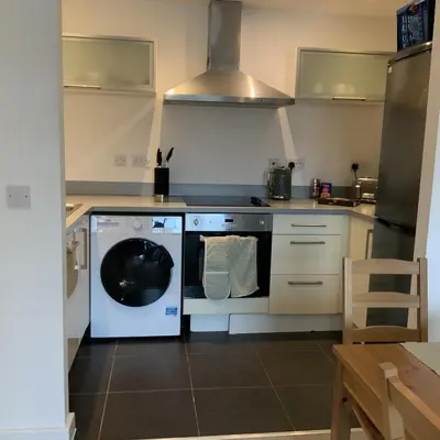 a kitchen with a dishwasher and a washer at Spacious City Centre 2 Bedroom Apartment in Liverpool