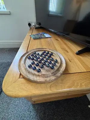 a wooden table with a bowl of blueberries on it at Garrick's Suite-Home away from Home- suitable for couples retreat, Contractors and NHS- free parking in Southport