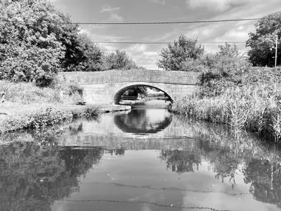 a black and white photo of a bridge over a river at Garrick's Suite-Home away from Home- suitable for couples retreat, Contractors and NHS- free parking in Southport
