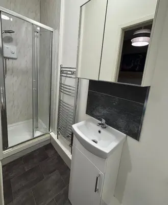 a bathroom with a toilet and a sink and a shower at Garrick's Suite-Home away from Home- suitable for couples retreat, Contractors and NHS- free parking in Southport