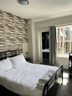 a bedroom with a bed with towels on it at The Sun Inn in Ulverston