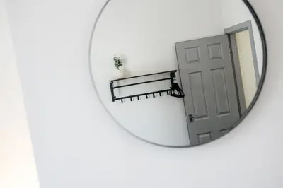 a mirror with a door reflection in it at Randolph House - Air Host & Stay - Sleeps 6 in Liverpool