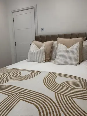 a bedroom with a bed with pillows on it at Seaside Retreat Luxury Apartment in Liverpool