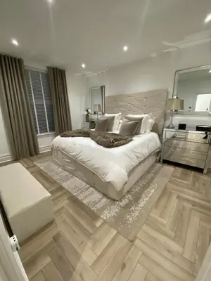 a bedroom with a large bed and a mirror at Seaside Retreat Luxury Apartment in Liverpool