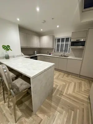 a kitchen with a table and a counter top at Seaside Retreat Luxury Apartment in Liverpool