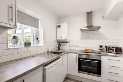 a white kitchen with a sink and a stove at Curlew Stays - Semi Detached Home - Pet Friendly in Thornton