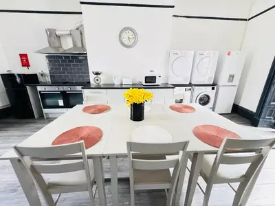 a kitchen with a white table and chairs at Pembroke Place Private Room 9 in Liverpool