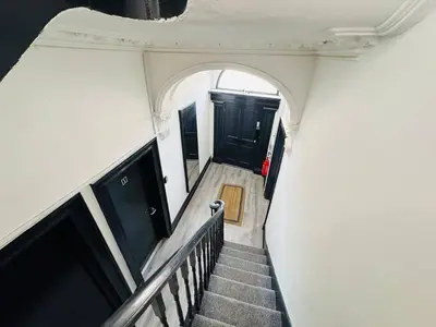 a view of a stairway with black doors and a stair case at Pembroke Place Private Room 9 in Liverpool