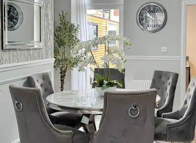 a dining room with a glass table and chairs at Garden, Free Parking, Smart TV, Self Check in in Liverpool