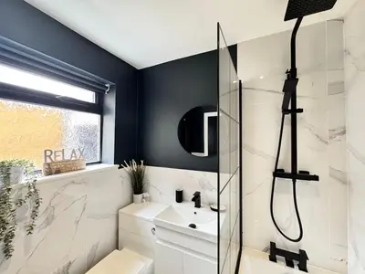 a bathroom with a shower and a sink at Garden, Free Parking, Smart TV, Self Check in in Liverpool