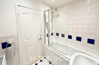 a bathroom with a shower and a sink and a mirror at Crews Cabin in Fleetwood