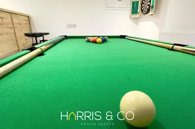 a green pool table with a ball on it at Crews Cabin in Fleetwood