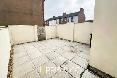 an empty courtyard in a building with a fence at Bosun's Bay in Fleetwood