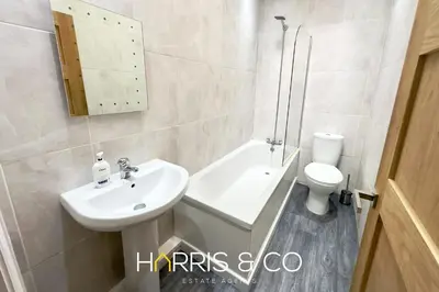 a white bathroom with a sink and a toilet at Bosun's Bay in Fleetwood