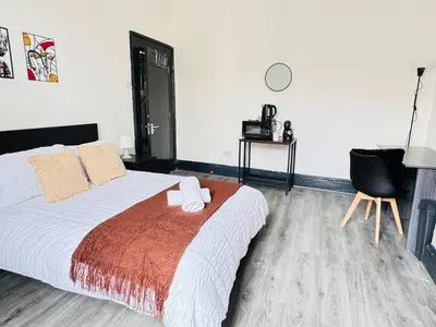 a bedroom with a bed and a chair at Pembroke Place Private Room 1 in Liverpool