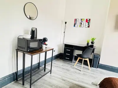a room with a desk and a tv and a mirror at Pembroke Place Private Room 1 in Liverpool
