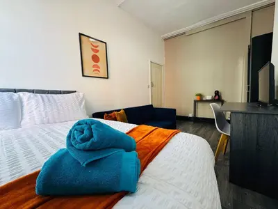 a bedroom with a bed with a blue towel on it at Pembroke Place Private Room 2 in Liverpool