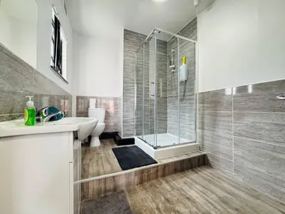 a bathroom with a shower and a sink and a toilet at Pembroke Place Private Room 2 in Liverpool
