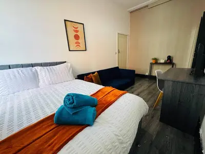 a bedroom with a bed with a blue towel on it at Pembroke Place Private Room 2 in Liverpool
