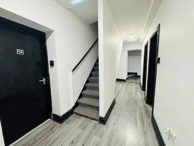 a hallway of an office with a black door and stairs at Pembroke Place Private Room 3 in Liverpool
