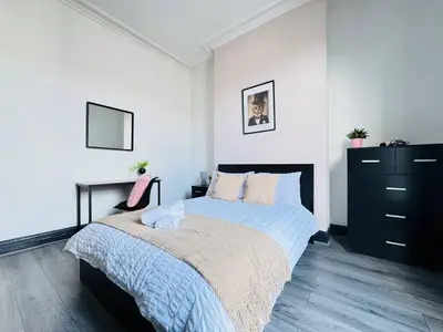 a bedroom with a bed and a black dresser at Pembroke Place Private Room 3 in Liverpool