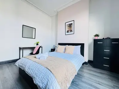 a bedroom with a bed and a black dresser at Pembroke Place Private Room 3 in Liverpool