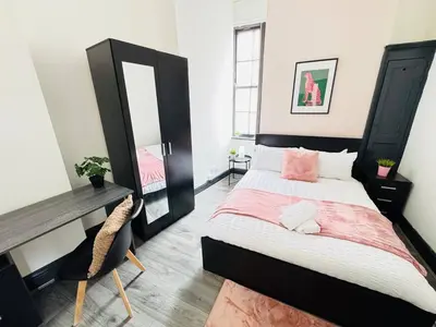 a bedroom with a bed and a desk and a mirror at Pembroke Place Private Room 4 in Liverpool