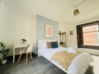 a bedroom with a bed and a desk and a window at Pembroke Place Private Room 6 in Liverpool
