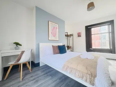 a white bedroom with a bed and a chair at Pembroke Place Private Room 6 in Liverpool
