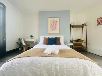 a bedroom with a large white bed with two pillows at Pembroke Place Private Room 6 in Liverpool