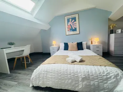 a bedroom with a large bed and a desk at Pembroke Place Private Room 7 in Liverpool