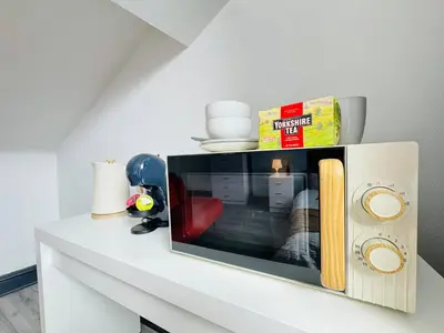 a white counter with a tv on top of it at Pembroke Place Private Room 7 in Liverpool