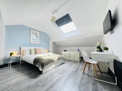 a bedroom with a bed and a desk and a tv at Pembroke Place Private Room 8 in Liverpool