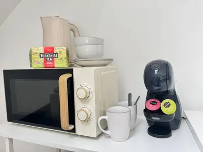 a microwave on a counter with cups and a coffee maker at Pembroke Place Private Room 8 in Liverpool