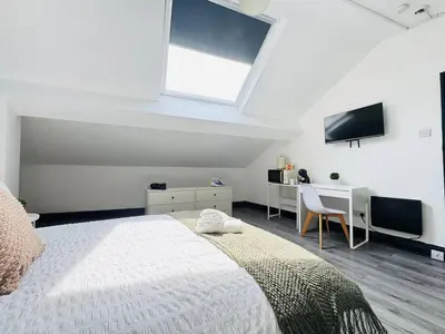 a bedroom with a bed and a desk and a tv at Pembroke Place Private Room 8 in Liverpool