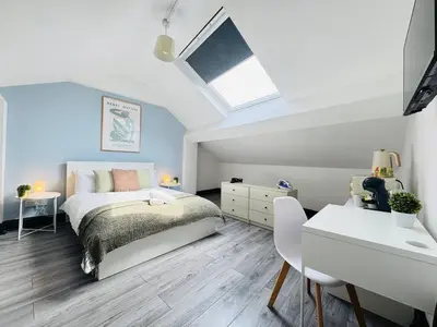 a bedroom with a bed and a desk and a window at Pembroke Place Private Room 8 in Liverpool