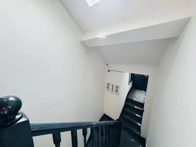 a staircase in a room with white walls and black stairs at Pembroke Place Private Room 11 in Liverpool
