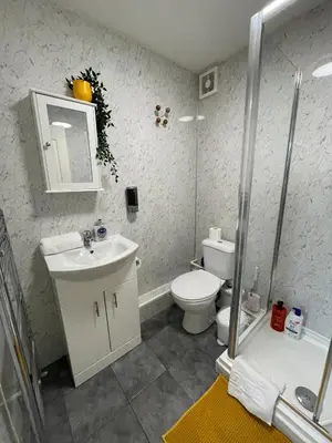 a bathroom with a toilet and a sink and a shower at The LFC Red House - Spacious House With 5 Bedrooms, 2 Bathrooms, Street Parking And 1 Minute From The Stadium in Liverpool