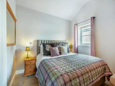 a bedroom with a bed and a window at The Coop in West Bradford
