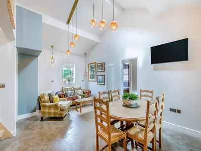 a dining room with a table and chairs at The Coop in West Bradford
