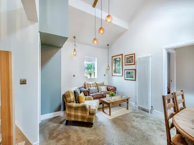 a living room with a couch and a table at The Coop in West Bradford